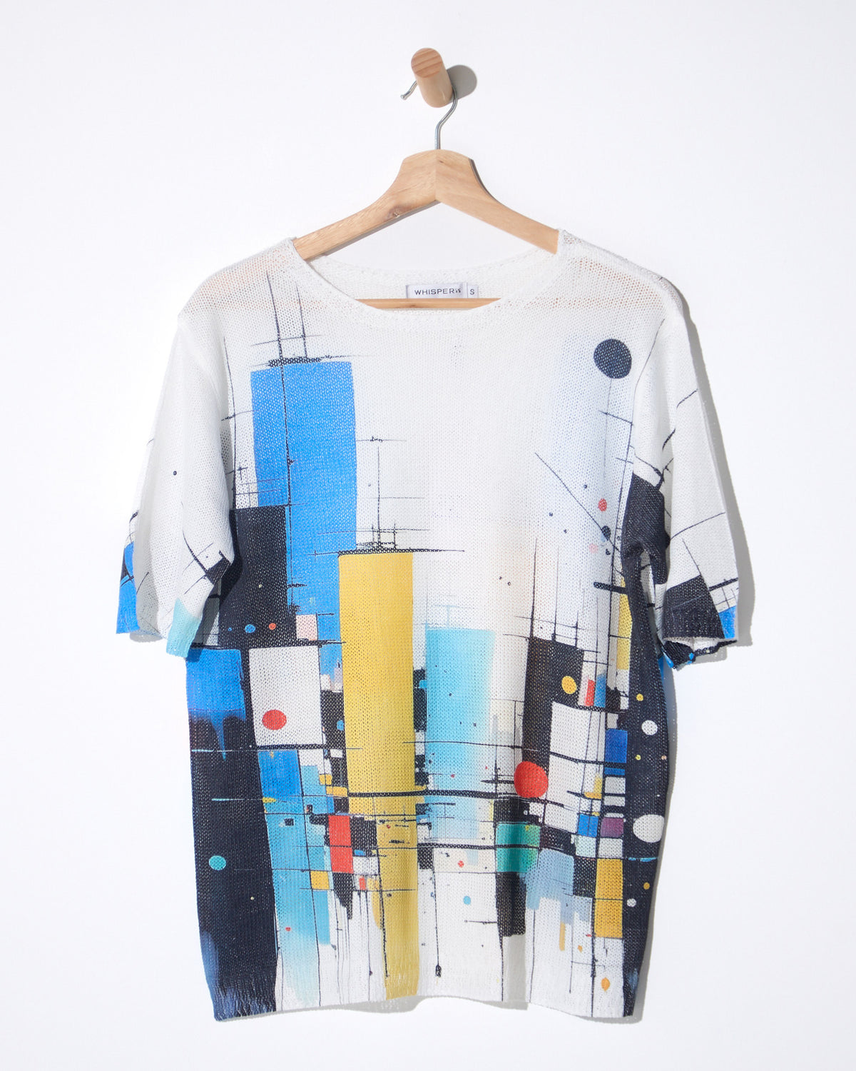 Caprina Knit Top in colour blocks, on a hanger showing the full front print