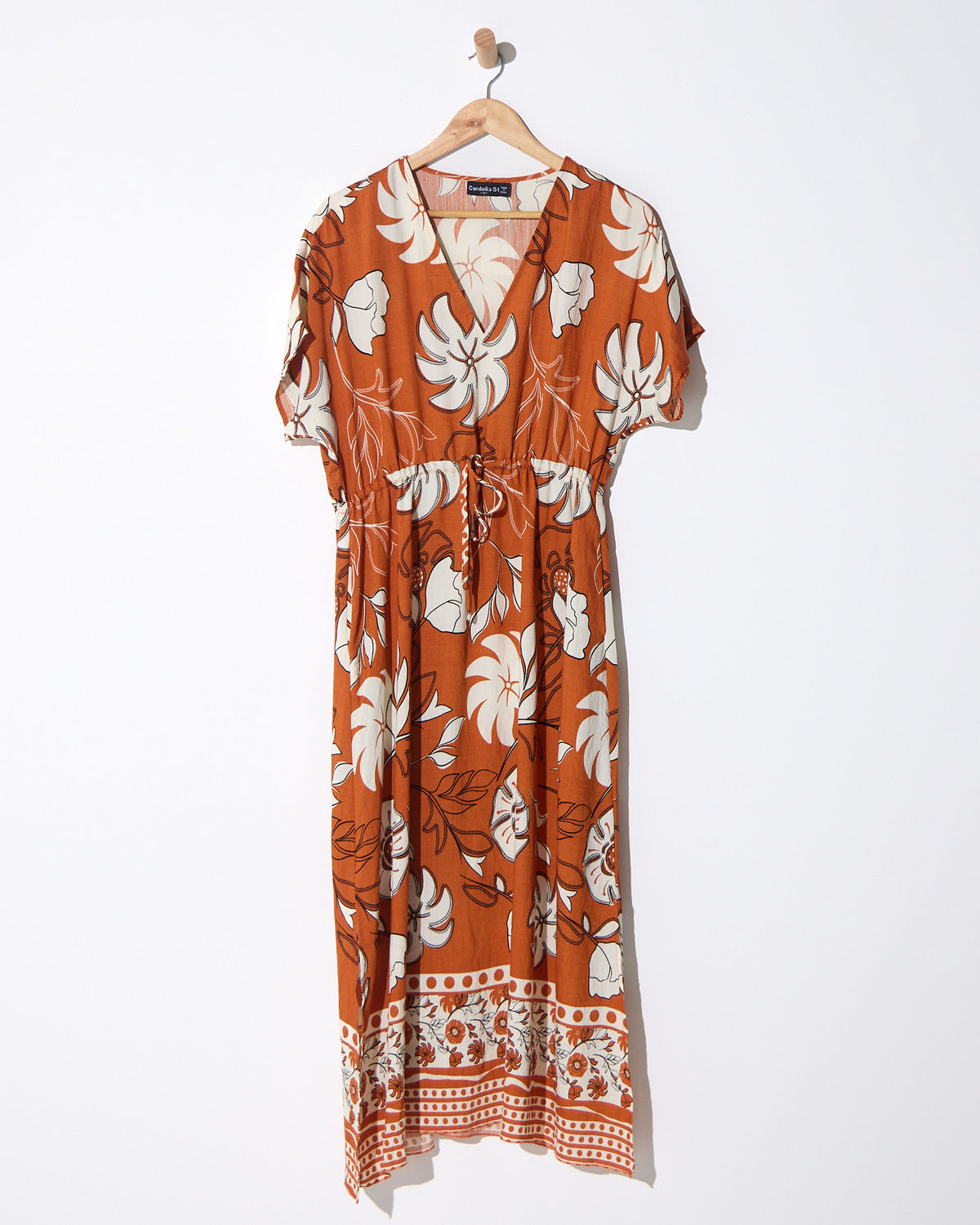 Montgomery Dress in toffee, on a hanger showing the full length and floral print