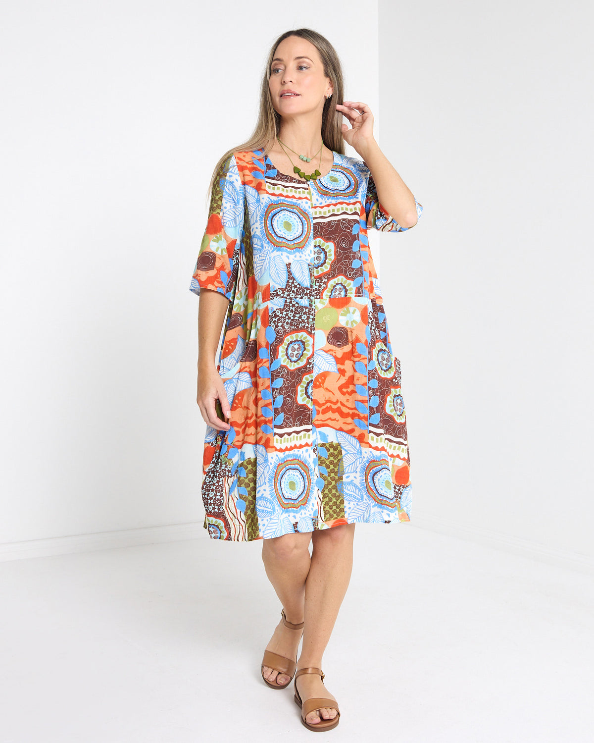 Eva Cotton Dress in ripple abstract print, full-length front view with elbow sleeves and round neckline