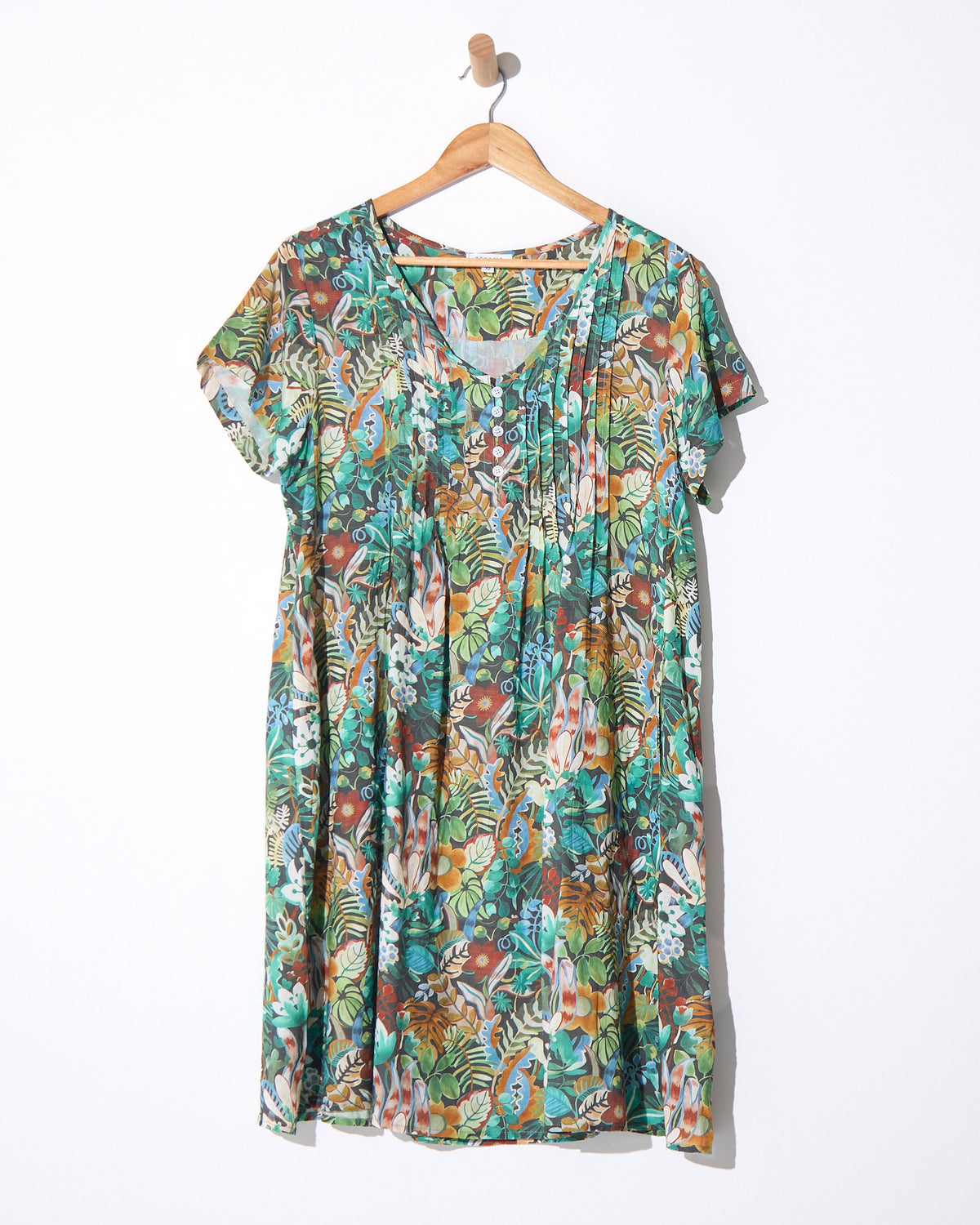 Hayes Cotton Dress in midnight jungle print, on a hanger showing the pintuck front and jungle print