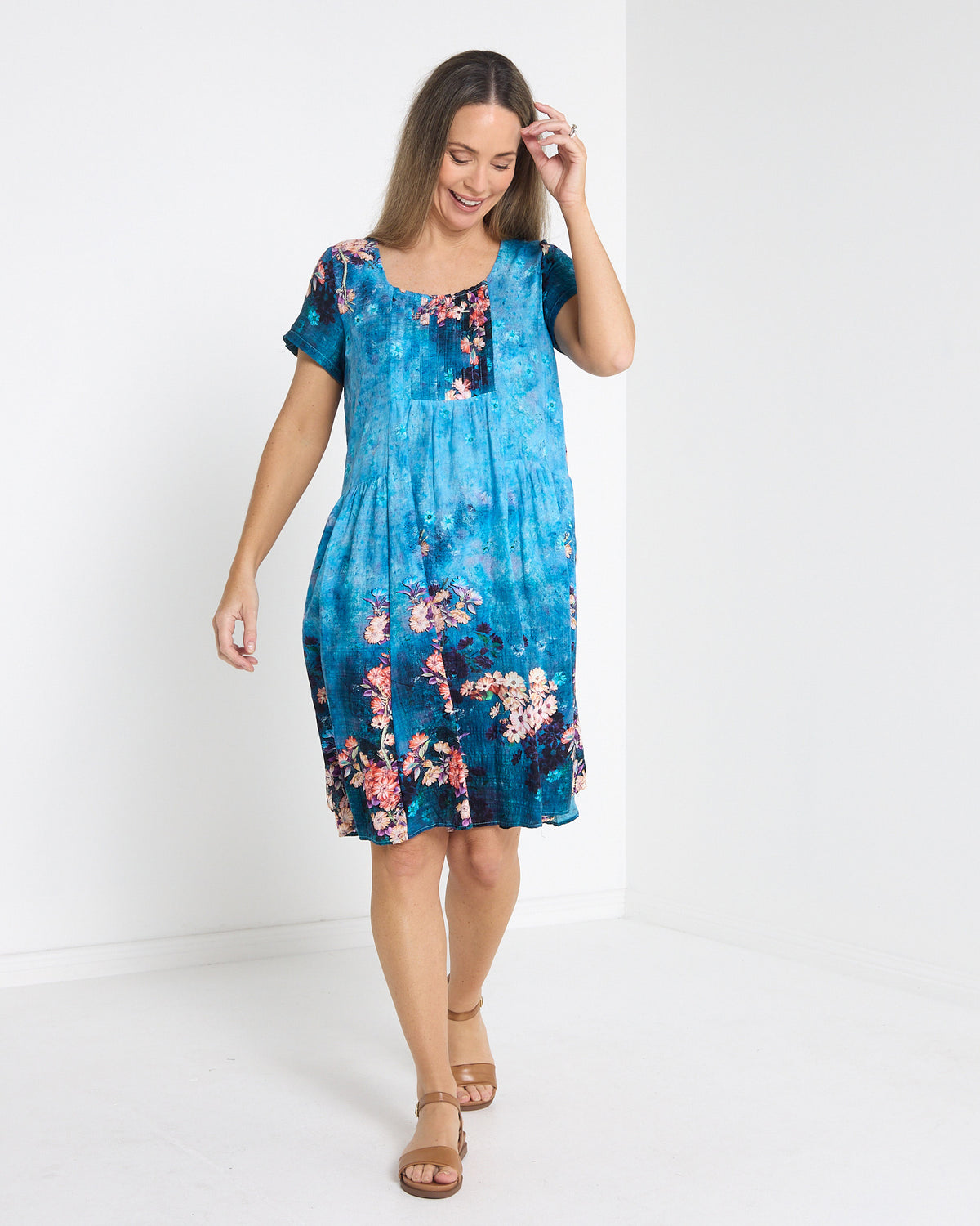 Emery Pintuck Dress in blue lagoon, front view in motion showing the swing skirt
