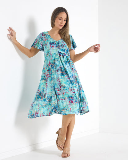 Cornwall Petite Dress in aqua mosaic print, front view showing the swing of the gathered skirt