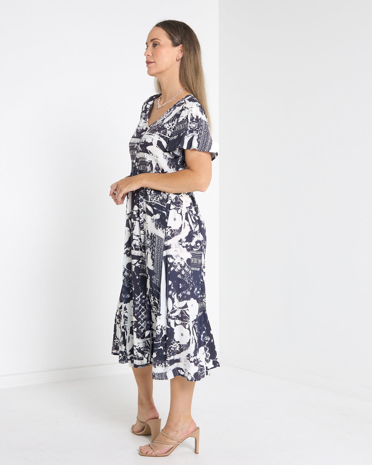 Cornwall Button Midi Dress in ink floral, side view showing the flutter sleeve and skirt