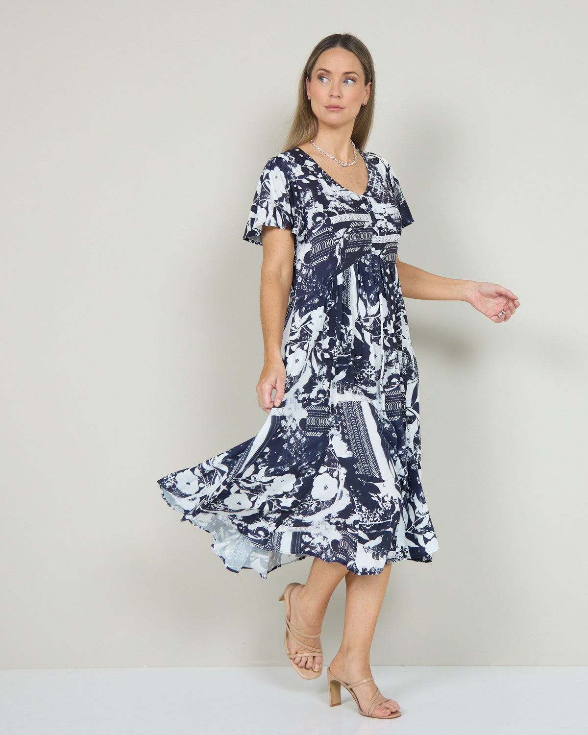 Cornwall Button Midi Dress in ink floral, view in motion showing the flared midi skirt