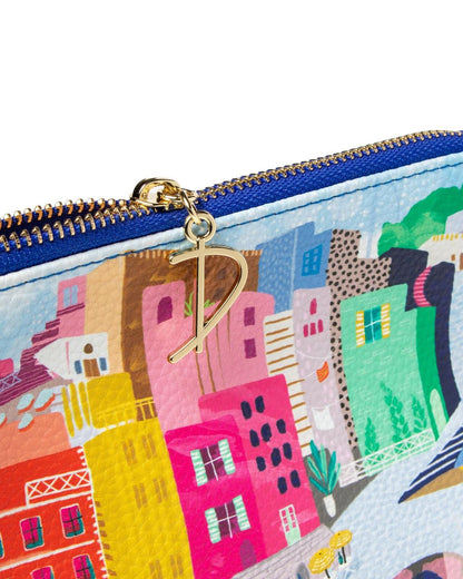 Colorful pouch with a cityscape design and gold zipper pull.