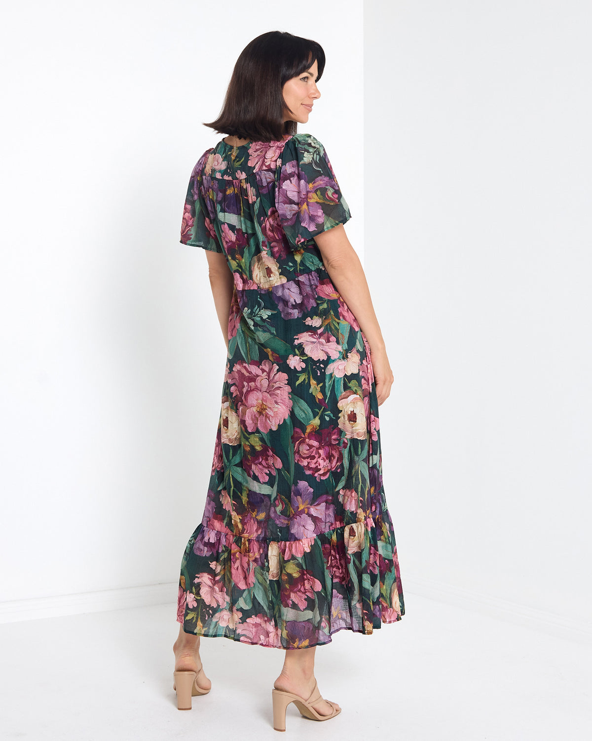 Cresida Party Dress in emerald floral, back view showing the ruffle hem