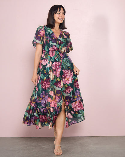 Cresida Party Dress in emerald floral, front view against a pink backdrop showing the front split