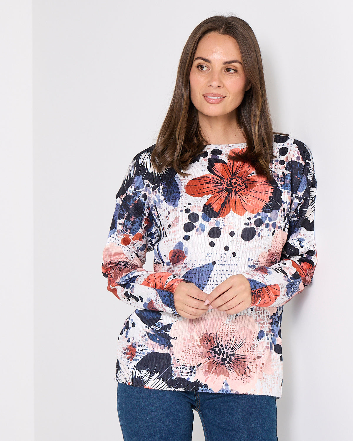 Woman wearing a floral patterned top against a white background