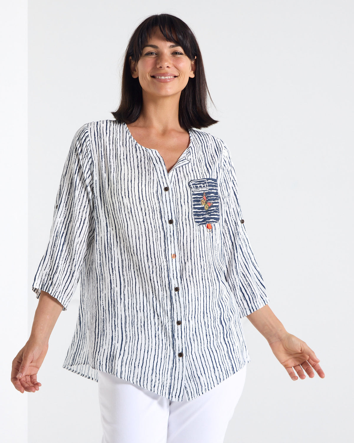 Gifford Stripe Blouse in navy, front view in motion showing the curved hem