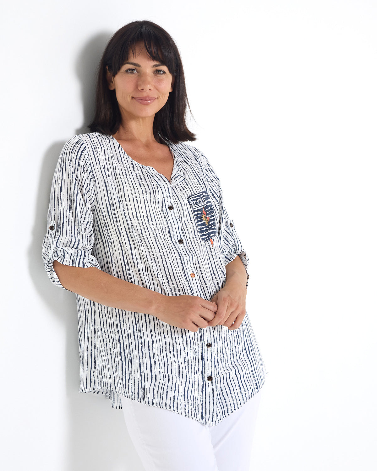 Gifford Stripe Blouse in navy, three-quarter view leaning on a wall