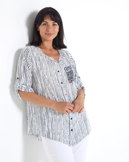 Gifford Stripe Blouse in navy, three-quarter view leaning on a wall