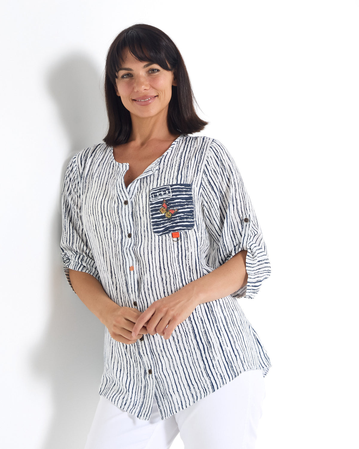 Gifford Stripe Blouse in navy, front view showing the curved hem and pocket detail