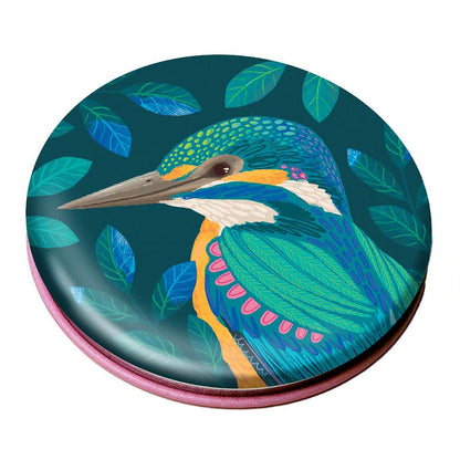 Round mirror with a colorful heron design on a green background