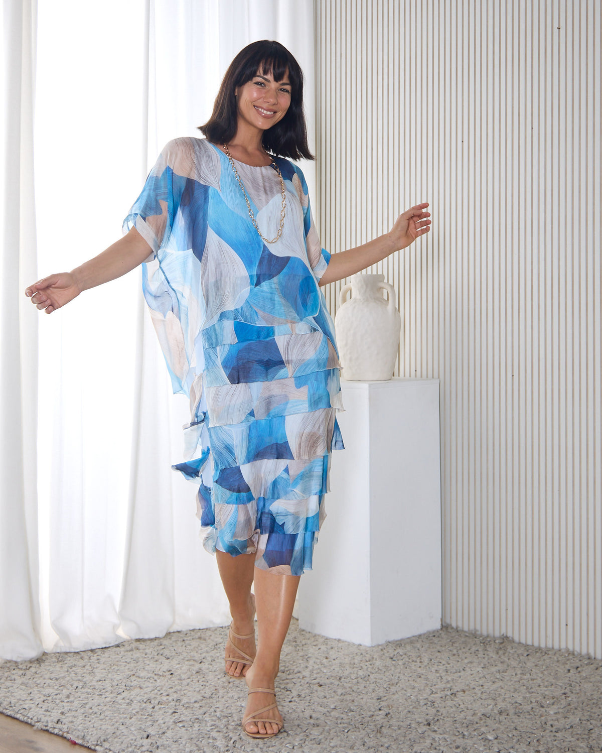 Margo Silk Layered Dress in Blue Celeste, mid-twirl in a room with sheer curtains