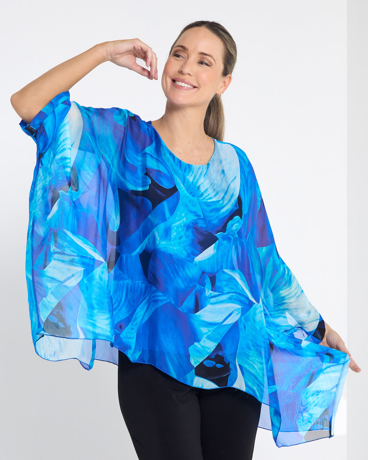Palermo Silk Top in blue floral, close front view of the blue leaf print and sheer drape