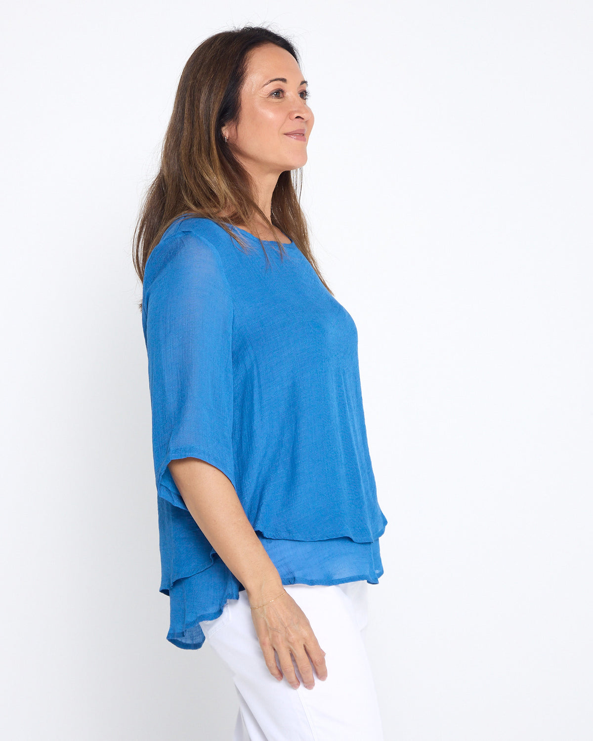 Leo Layered Top in denim blue, side view showing the sleeve and hem layers