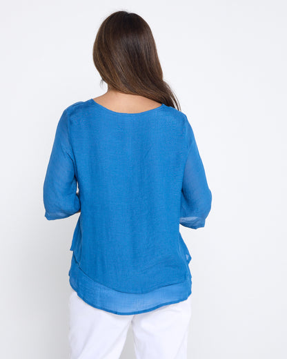 Leo Layered Top in denim blue, back view with double-layered hem