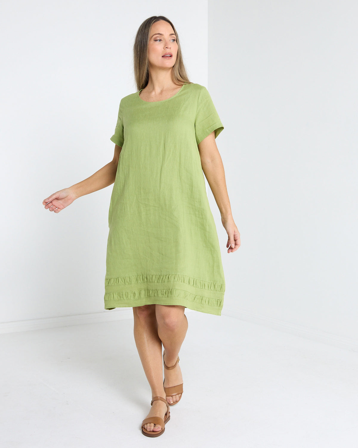 Lux Linen Shift Dress in pistachio, front view in motion showing the relaxed fit