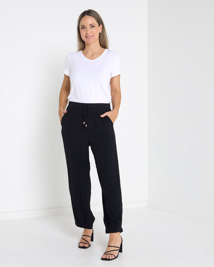 Venus Drawstring Tapered Pants in black, full-length view worn with a white tee and heels