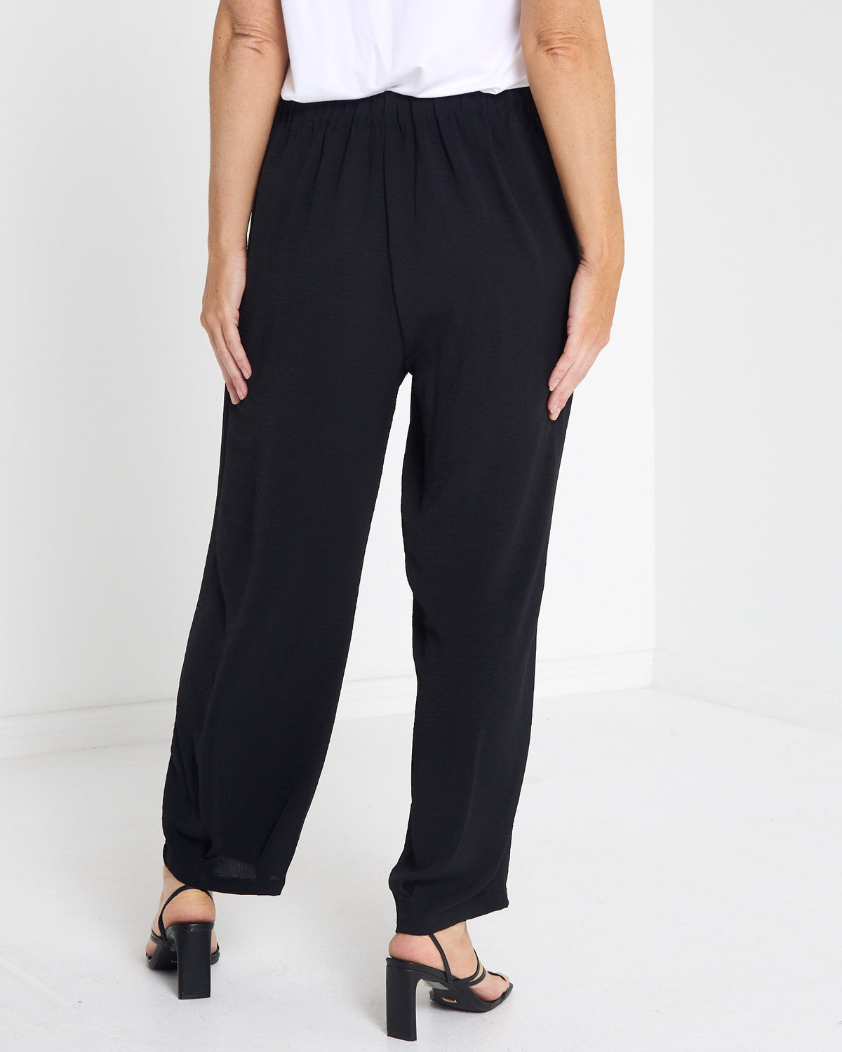 Venus Drawstring Tapered Pants in black, back view with elastic waist