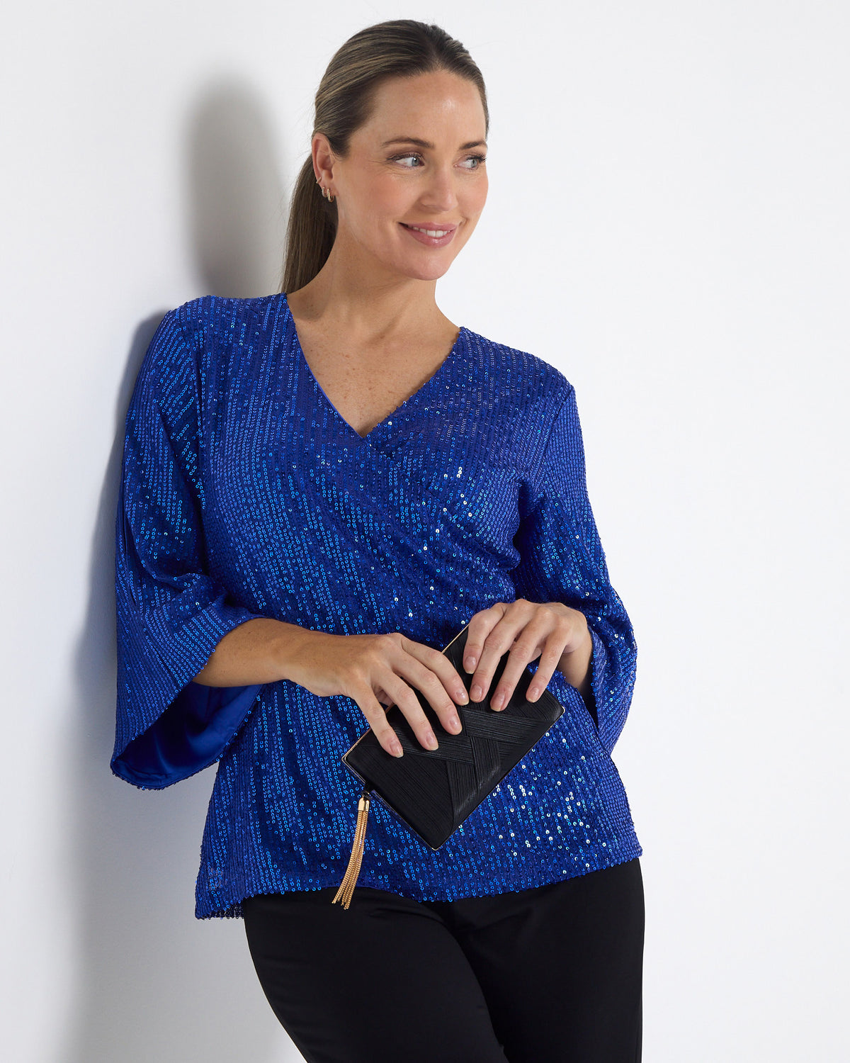 Sparkle Sequin Top in electric blue, front view of the crossover V neckline and flared sleeves