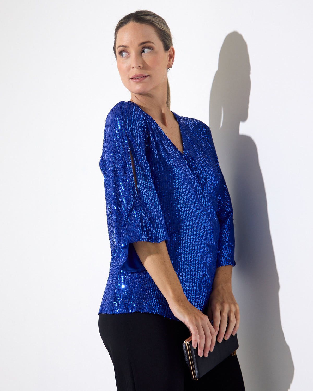 Sparkle Sequin Top in electric blue, three-quarter side view with split sleeve detail