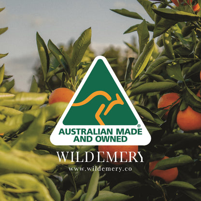 Wild Emery logo with Australian made and owned text over a background of green leaves and oranges.