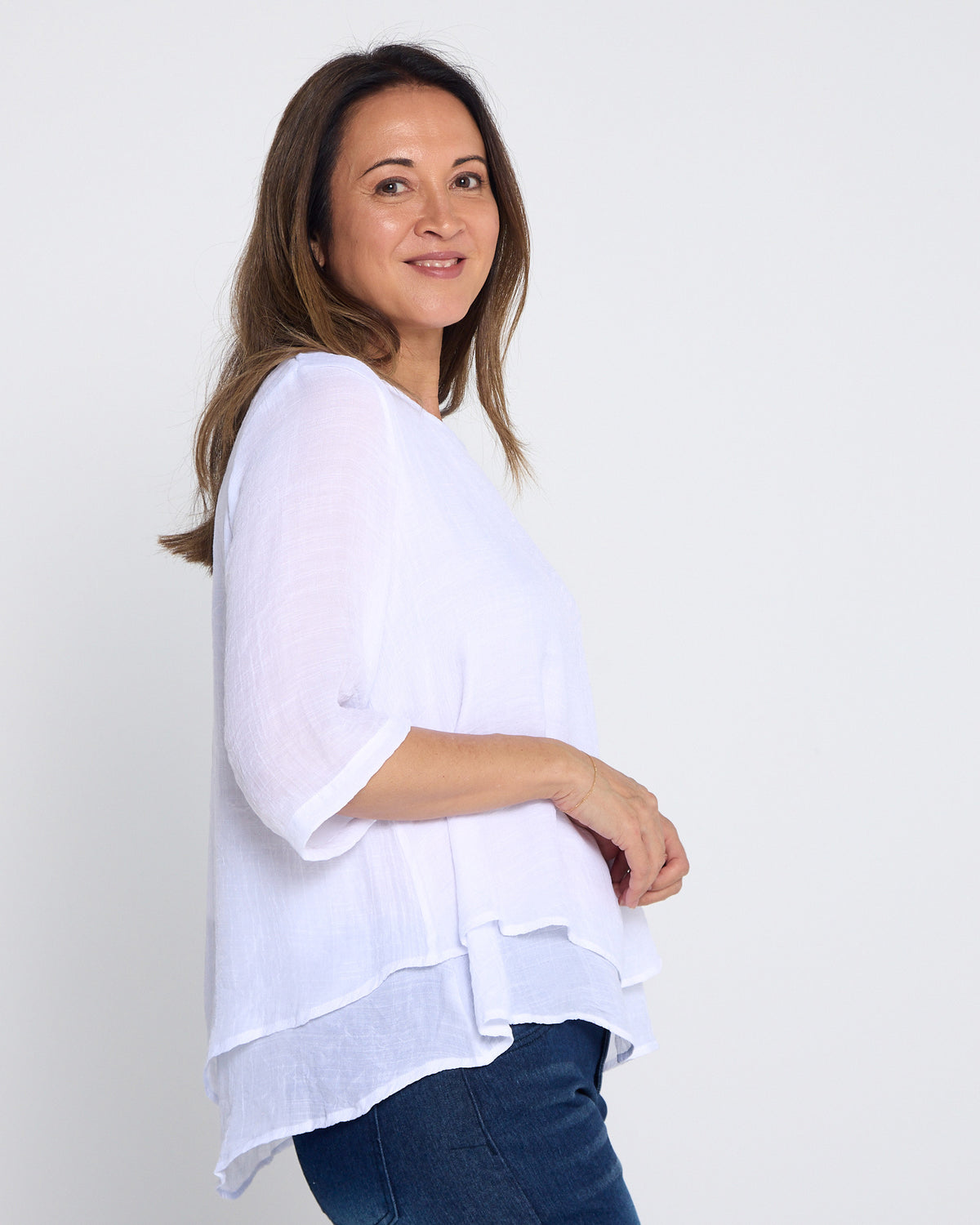 Leo Layered Top in white, side view showing the layered hem length