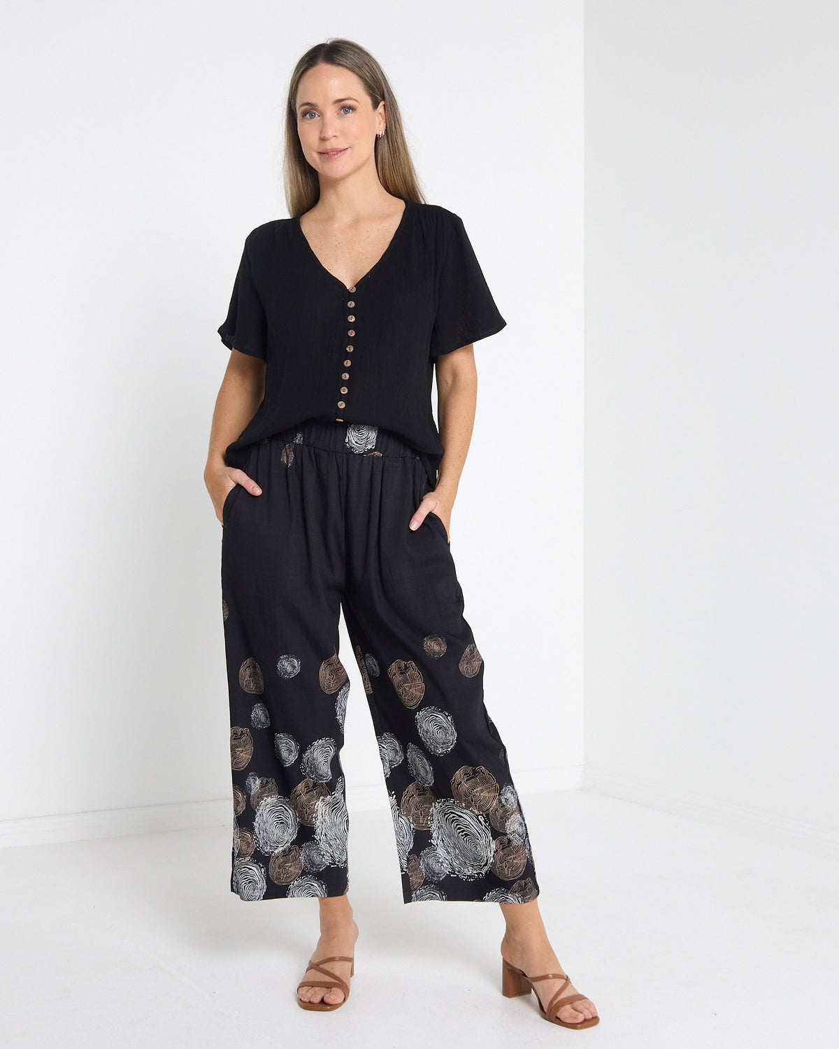 Tarin Button Top in black, full-length front view with printed cropped pants and sandals