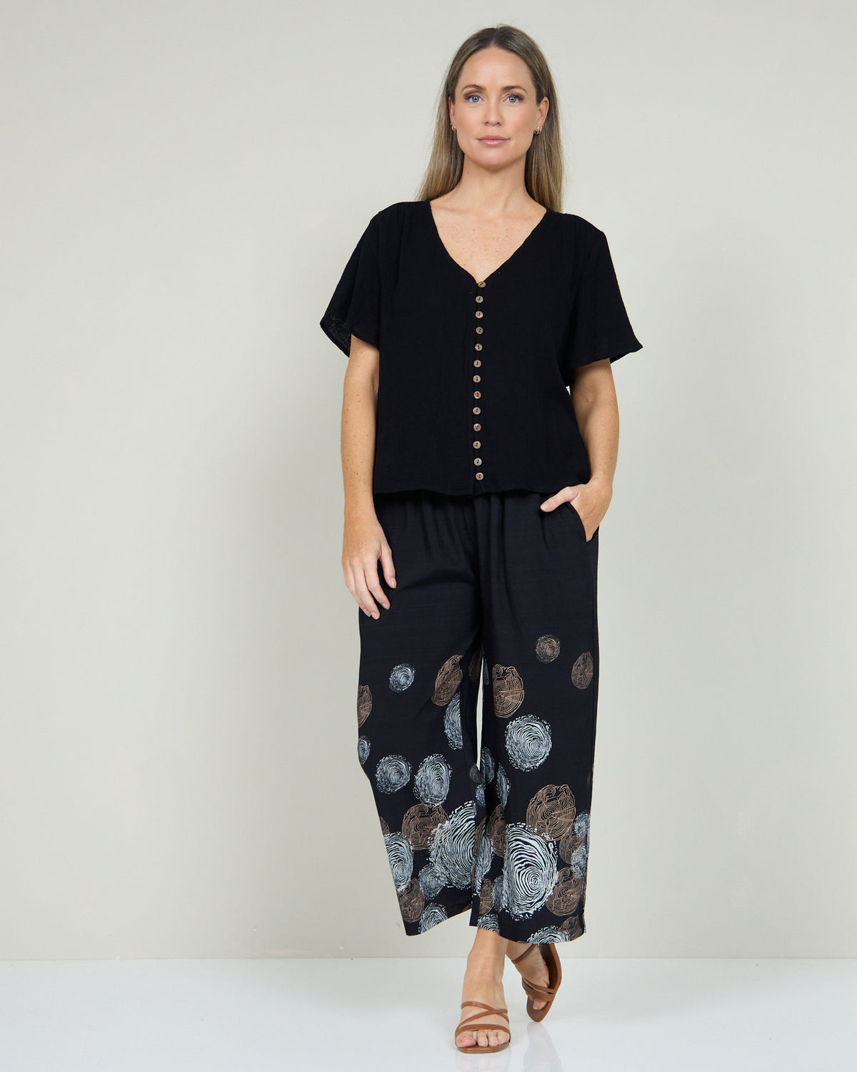 Tarin Button Top in black, full-length view styled with printed wide-leg pants