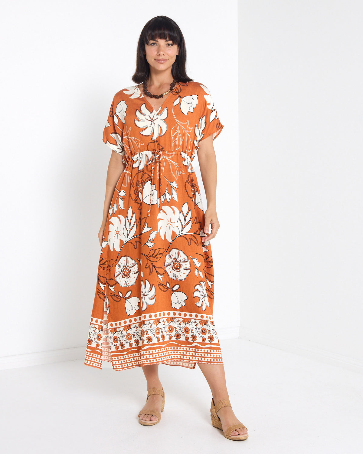 Montgomery Dress in toffee, full-length front view with side split and wedge sandals