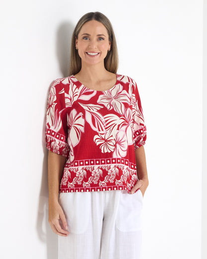 Falkiner Border Print Top in red, front view with round neckline and gathered sleeve cuffs