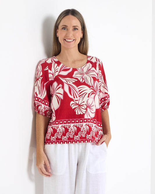Falkiner Border Print Top in red, front view with round neckline and gathered sleeve cuffs