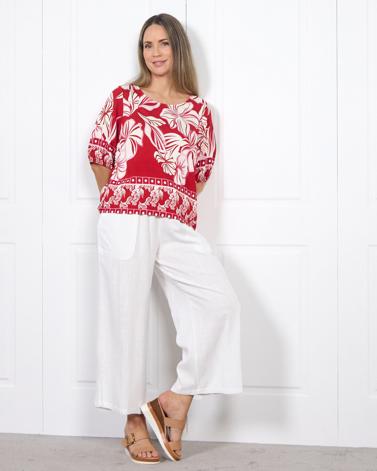 Falkiner Border Print Top in red, full-length view worn with white pants and sandals