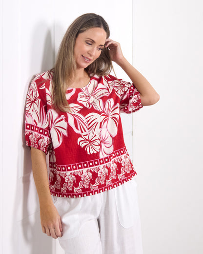 Falkiner Border Print Top in red, front view showing the border print hem and puff sleeves