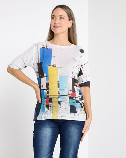 Caprina Knit Top in colour blocks, front view with hand on hip, showing the abstract print